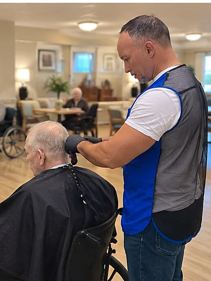 On-site barber visit at a nursing home common room by Hair & Cuts